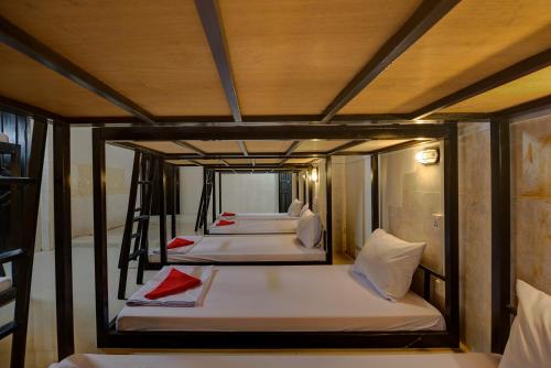 a group of four beds in a room at Siem Reap Pub Hostel in Siem Reap