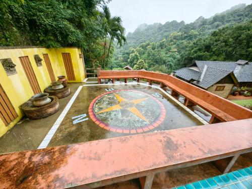 a view of a building with a clock on the ground at Insda Wellness Resort in Chiang Mai