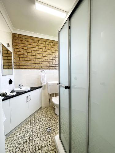 a bathroom with a toilet and a sink at Squatters Homestead Motel in Casino