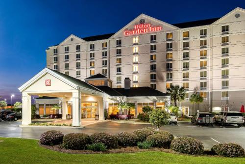 a hotel garden inn building with a parking lot at Hilton Garden Inn Florence in Florence