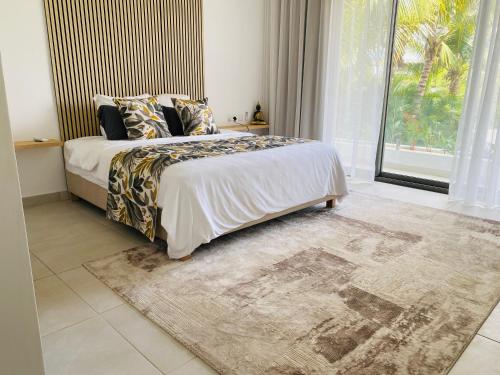Ένα ή περισσότερα κρεβάτια σε δωμάτιο στο Appt super luxe 3 chambres Pointe aux Canonniers