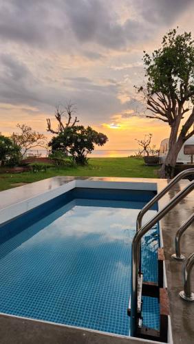 a swimming pool with a view of the ocean at White House Beach Camping Caravans in Ban Thai Don (2)
