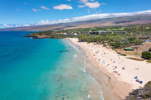 an aerial view of a beach with people on it at HOME OF THE MILKY WAY Breathtaking Home Overlooking Ocean with Observatory in Kawaihae