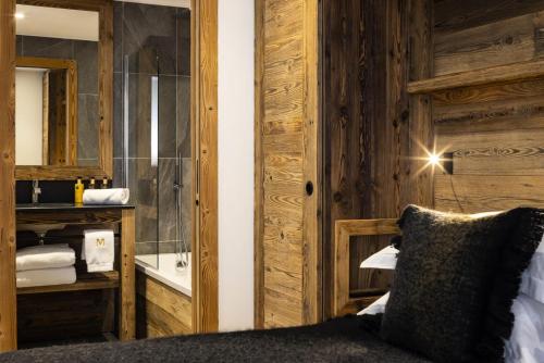 une chambre avec un lit et un miroir dans une pièce dans l'établissement Résidence Caseblanche - Chalet MCFOGGIN MAE-9011, à Saint-Martin-de-Belleville