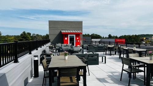 a restaurant with tables and chairs on a roof at avid hotel Wisconsin Dells Lake Delton by IHG in Wisconsin Dells