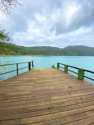 a wooden pier with a view of the water at Pousada Ponta da Ilha, Ilha Grande, Angra dos Reis in Angra dos Reis