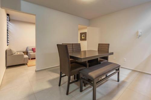 a dining room with a table and chairs at Lofts By Verticca in Santa Cruz Tecamac