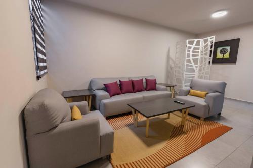 a living room with a couch and a table at Lofts By Verticca in Santa Cruz Tecamac