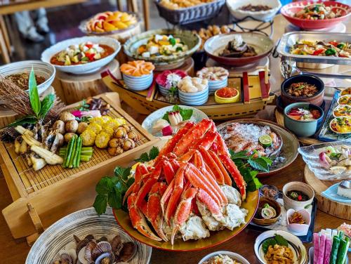 a buffet of different types of food on a table at REBUN Hotel SARYO in Kafuka