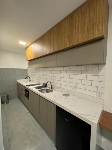 a kitchen with a sink and a counter top at Mar de Maragogi Flats in Maragogi