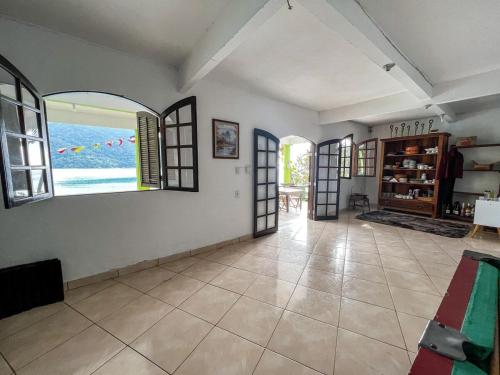 an empty room with windows and a room with a view at Pousada Ponta da Ilha, Ilha Grande, Angra dos Reis in Angra dos Reis