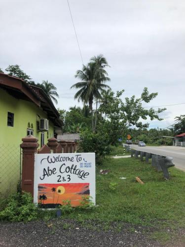 a sign for a cafe coffee next to a building at Abe.Cottage 3 in Kampong Chawat