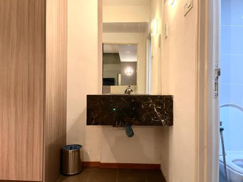 a bathroom with a sink and a mirror at HillLand Suites in Ayer Keroh