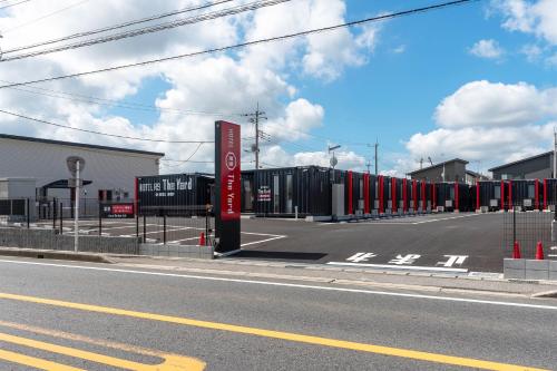 a row of shipping containers sitting on the side of a road at HOTEL R9 The Yard Mobara in Mobara