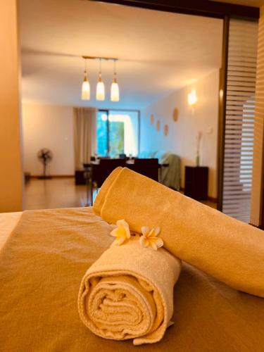 a rolled up towel on a bed in a room at Belle Haven GF 1bedroom flat in Mont Choisy