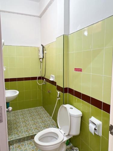 a bathroom with a toilet and a sink at เอส บี โฮเทล SB Hotel in Betong