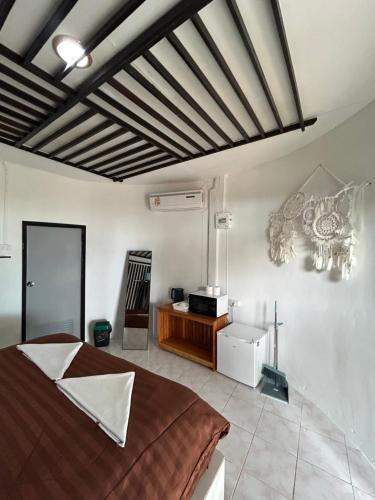 a bedroom with a bed and a television in a room at Ban Tai Bay Bungalows in Ban Tai