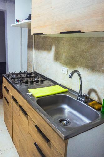 a kitchen with a sink and a stove at Coliving La Rebeca Pereira in Pereira