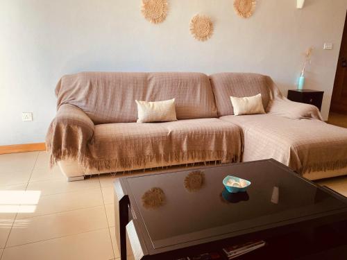 a living room with a couch and a table at Belle Haven GF 1bedroom flat in Mont Choisy
