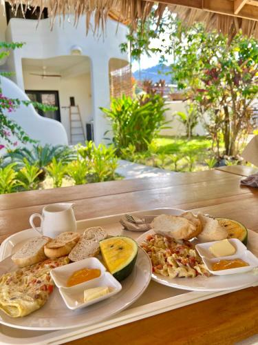 a table with two plates of breakfast food on it at Parrots Boutique Resort in San Vicente