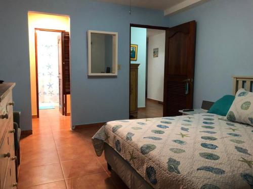 a bedroom with a bed and a door to a hallway at En el Mar in Nueva Gorgona