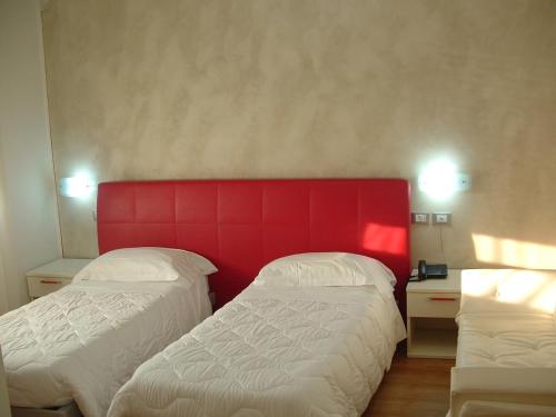 En eller flere senger på et rom på Hotel Toscana