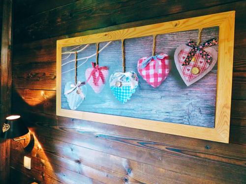 a picture of four hearts hanging on a wall at Chalet Chez Gaby - Quartier calme proche du centre in Morzine