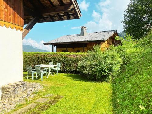 a patio with a table and chairs in front of a house at Chalet Chez Gaby - Quartier calme proche du centre in Morzine