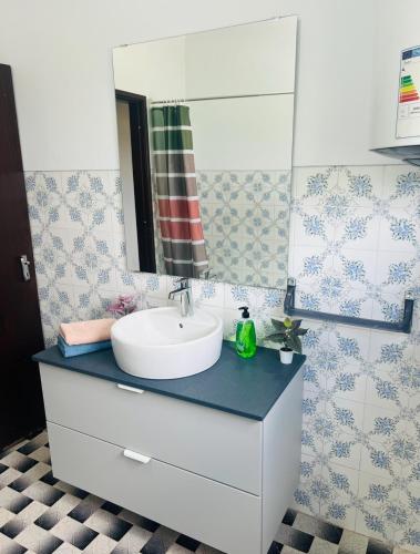 a bathroom with a sink and a mirror at Lugar de Passos in Sesimbra