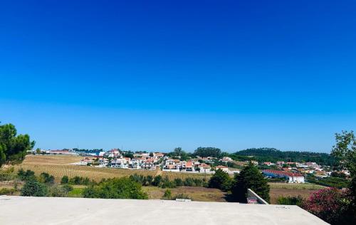 a view of a town from the roof of a house at Lugar de Passos in Sesimbra