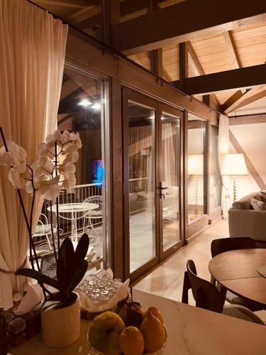 a living room with a table with flowers on it at REY Chalet in Vatra Dornei