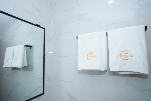 a mirror and towels hanging on a wall at Gonzales Hotel in Cauayan