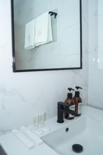 a bathroom counter with a mirror and a sink at Gonzales Hotel in Cauayan