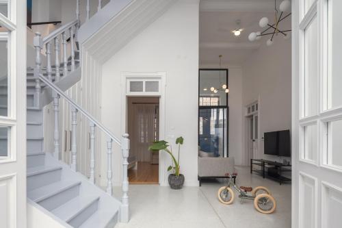 a living room with a staircase and a toy bike in the middle at 1924 Gemini House Jacuzzi, Garden, Rooftop in Nicosia