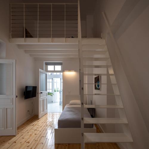 a bedroom with a loft bed and a staircase at 1924 Gemini House Jacuzzi, Garden, Rooftop in Nicosia