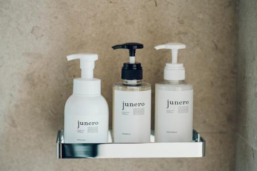 three bottles of shampoo and conditioner on a shelf at Kikka Hirado in Hirado