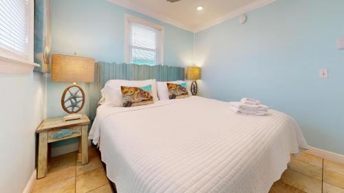a bedroom with a large white bed in a room at Sunflower 1 in St. George Island