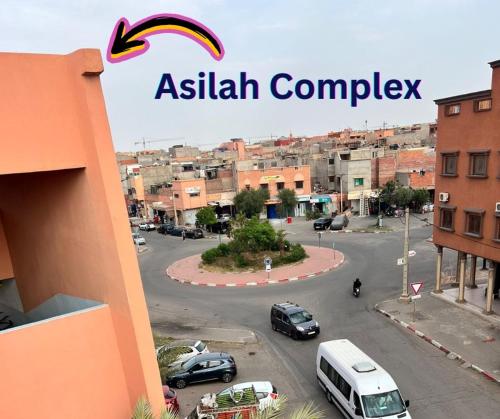 a sign for an asian complex in a city at Julie Airport Marrakech Apartments in Marrakech