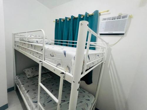a bunk bed in a room with a fan at Rej Homestay in Lipa
