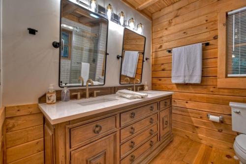 a bathroom with a sink and a mirror at Blueberry Hill - Relax in the Hot Tub or Roast Marshmallows by the Firepit in Blue Ridge