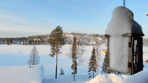 a building covered in snow in a snowy field at Holiday Apartment Skivillas 26 B 9 in Ukkohalla