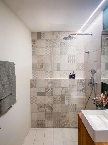 a bathroom with a shower and a sink at Chasa Savü in Guarda