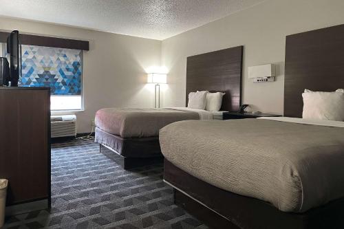 Postel nebo postele na pokoji v ubytování Quality Inn