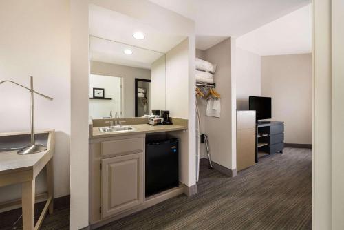 a bathroom with a sink and a mirror at Country Inn & Suites by Radisson, Freeport, IL in Freeport