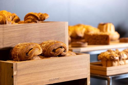 two wooden boxes filled with breads and pastries at Hotel La Diligence in Obernai