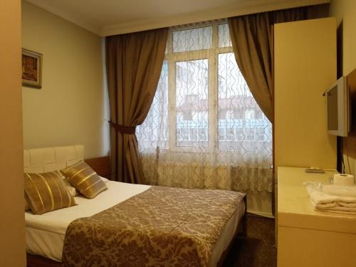 Postel nebo postele na pokoji v ubytování Tac Hotel