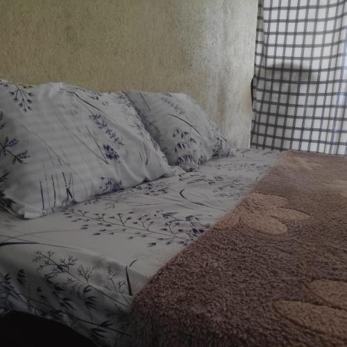 a bed with white sheets and pillows on it at BeVibe in Malabe