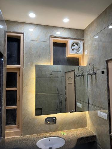 a bathroom with a sink and a mirror at Hotel C Park, Karol Bagh, New Delhi in New Delhi