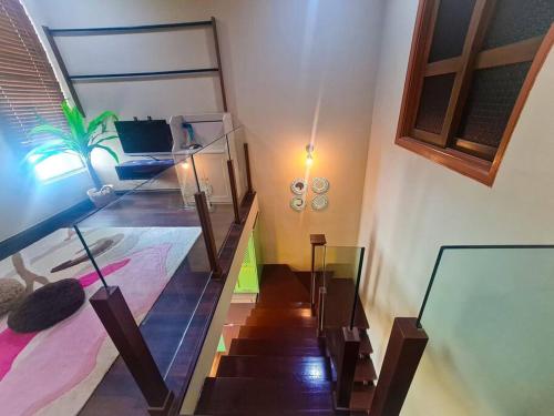 a room with a staircase and a bed and a room with a stair case at Premium Vintage Home 2 Master Bedrooms 2 to 4 Pax Comfy Stay for Friends and Family in Cyberjaya