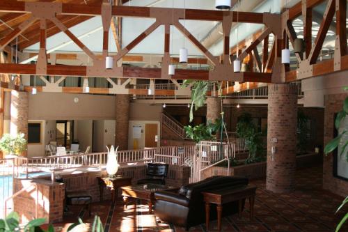 a lobby with a couch and tables in a building at Red Lion Hotel and Conference Center St. George in St. George